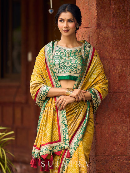 Exquisite Mustard Bandhani Print Saree with Green Benarasi Border & Tasseled Pallu with Hand Embroidered Mirror Work