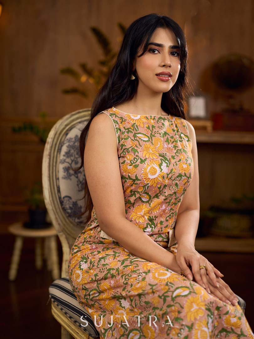 Summery mustard and peach floral sleeveless dress featuring a boat neckline and Hakoba pocket detailing, finished with soft off-white accents for a breezy, cheerful silhouette perfect for warm days.