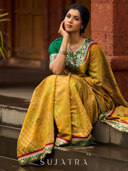 Exquisite Mustard Bandhani Print Saree with Green Benarasi Border & Tasseled Pallu with Hand Embroidered Mirror Work