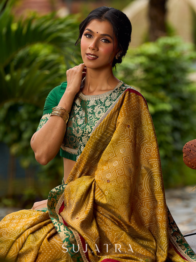 Exquisite Mustard Bandhani Print Saree with Green Benarasi Border & Tasseled Pallu with Hand Embroidered Mirror Work