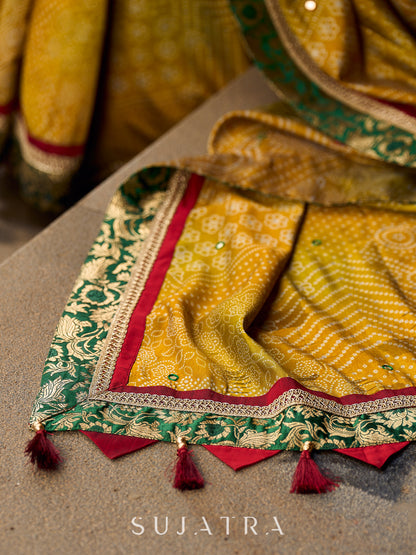 Exquisite Mustard Bandhani Print Saree with Green Benarasi Border & Tasseled Pallu with Hand Embroidered Mirror Work