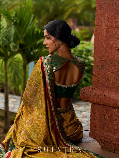 Exquisite Mustard Bandhani Print Saree with Green Benarasi Border & Tasseled Pallu with Hand Embroidered Mirror Work