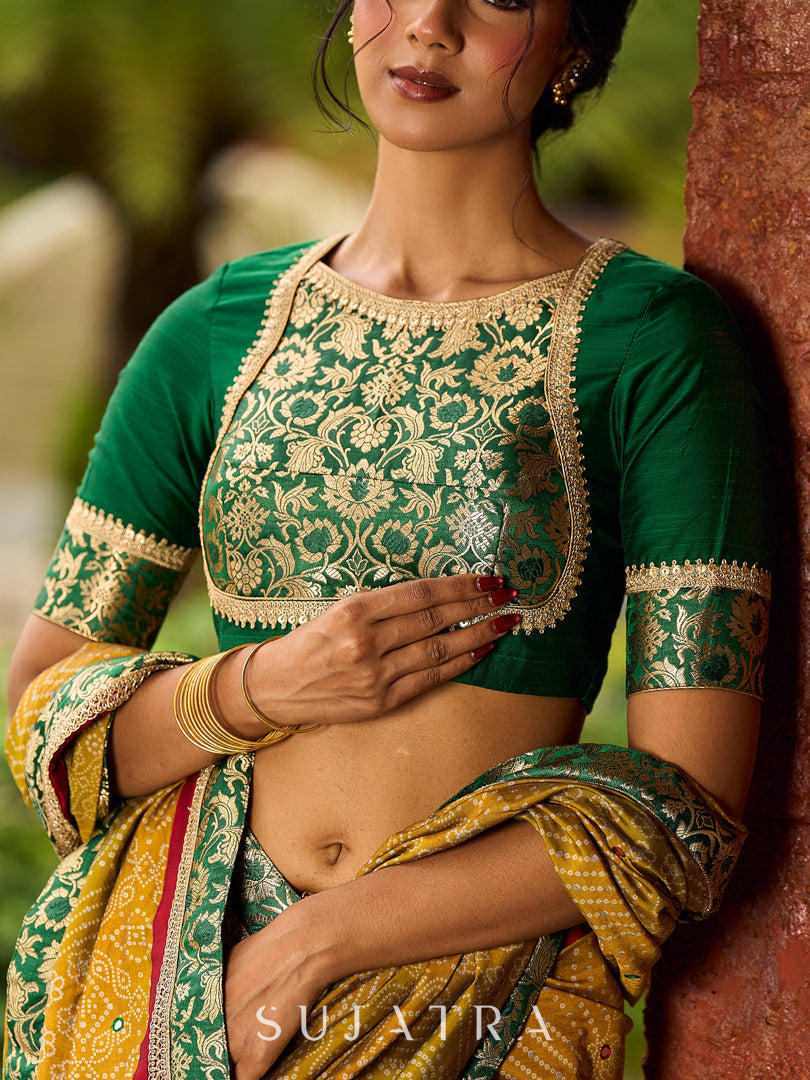 Exquisite Mustard Bandhani Print Saree with Green Benarasi Border & Tasseled Pallu with Hand Embroidered Mirror Work