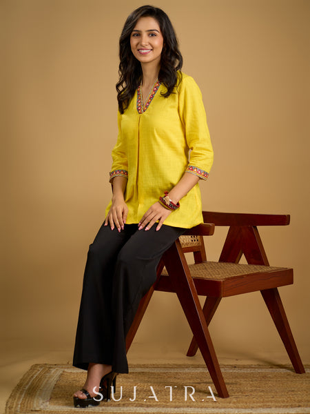 Traditional madhubani hand painting enhances this bright yellow cotton top.