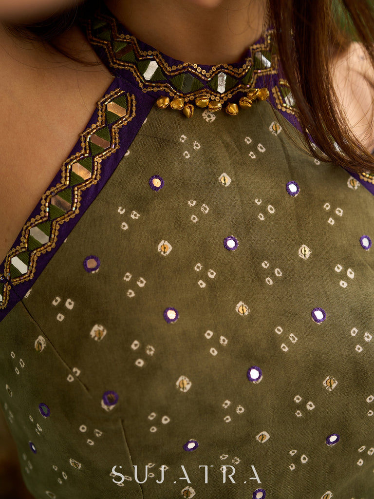 Vibrant Mehendi green and purple bandhani lehenga paired with a mirror work halter neck choli and matching dupatta.