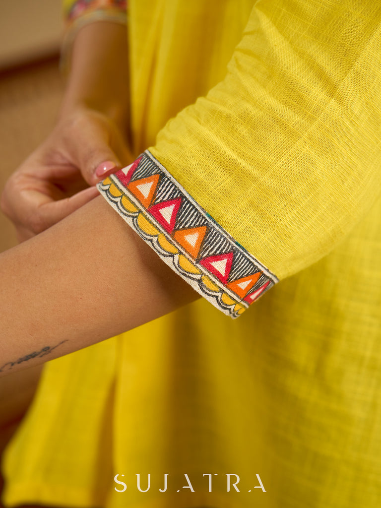 Traditional madhubani hand painting enhances this bright yellow cotton top.