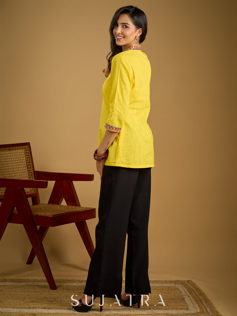 Traditional madhubani hand painting enhances this bright yellow cotton top.