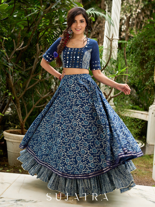 Modern folkloric layered indigo lehenga beautifully contrasted with a luminous full mirror work choli - Lehriya dupatta optional.