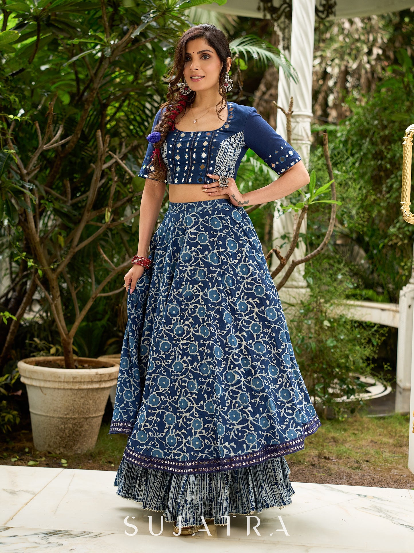 Modern folkloric layered indigo lehenga beautifully contrasted with a luminous full mirror work choli - Lehriya dupatta optional.