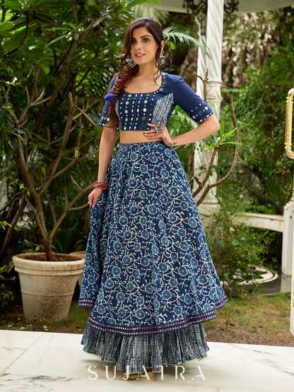 Modern folkloric layered indigo lehenga beautifully contrasted with a luminous full mirror work choli - Lehriya dupatta optional.