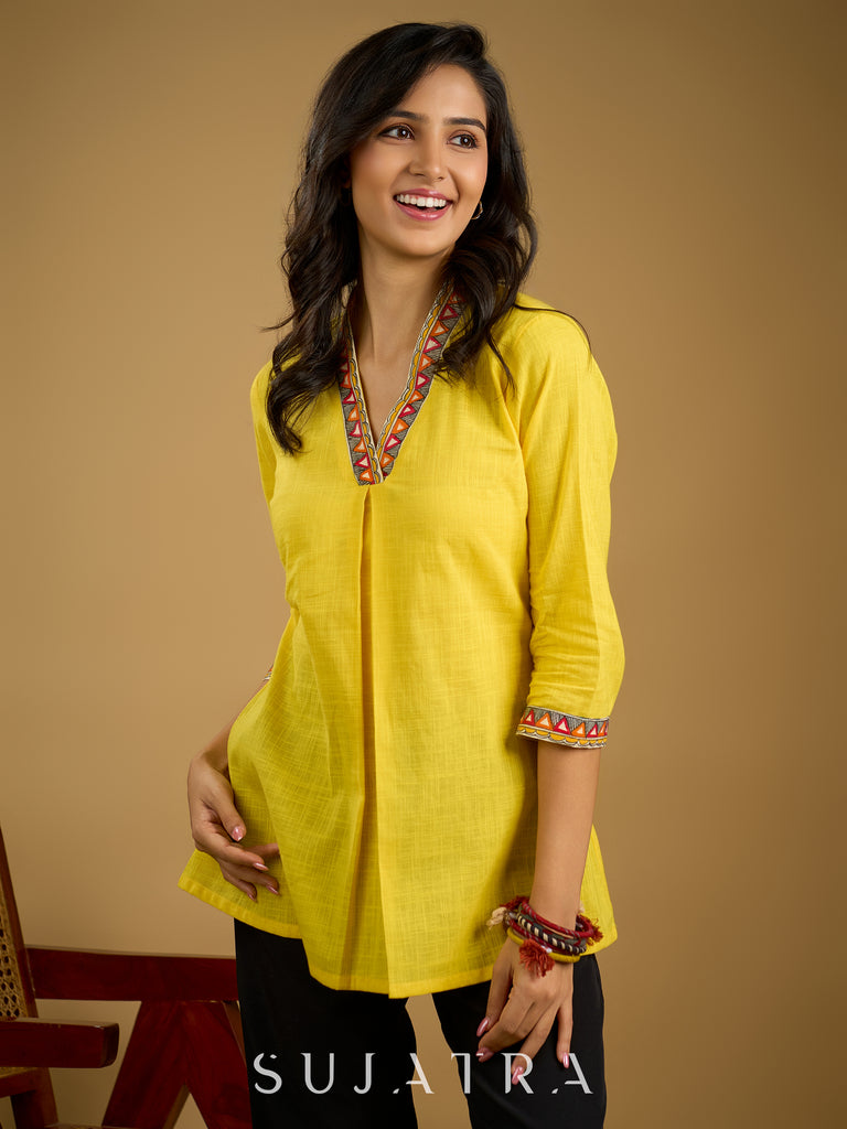 Traditional madhubani hand painting enhances this bright yellow cotton top.