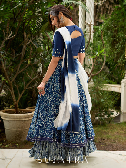 Modern folkloric layered indigo lehenga beautifully contrasted with a luminous full mirror work choli - Lehriya dupatta optional.