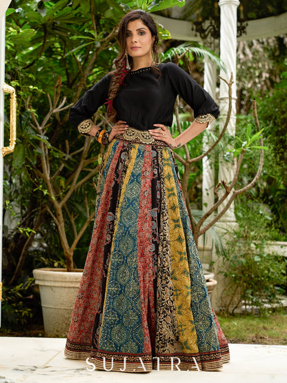 Modern colourful Ajrakh lehenga beautifully contrasted by a sleek black gathered topwear.