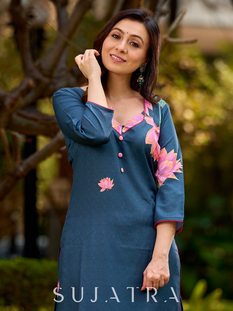 Graceful teal kurta with delicate pink lotus printing, subtle pink accents, and a statement patch above the neckline.
