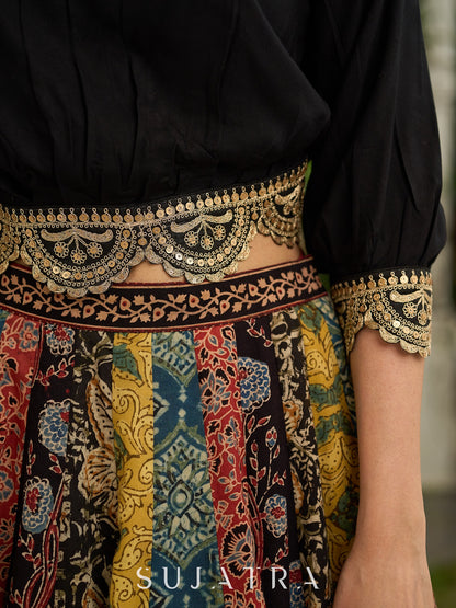 Modern colourful Ajrakh lehenga beautifully contrasted by a sleek black gathered topwear.