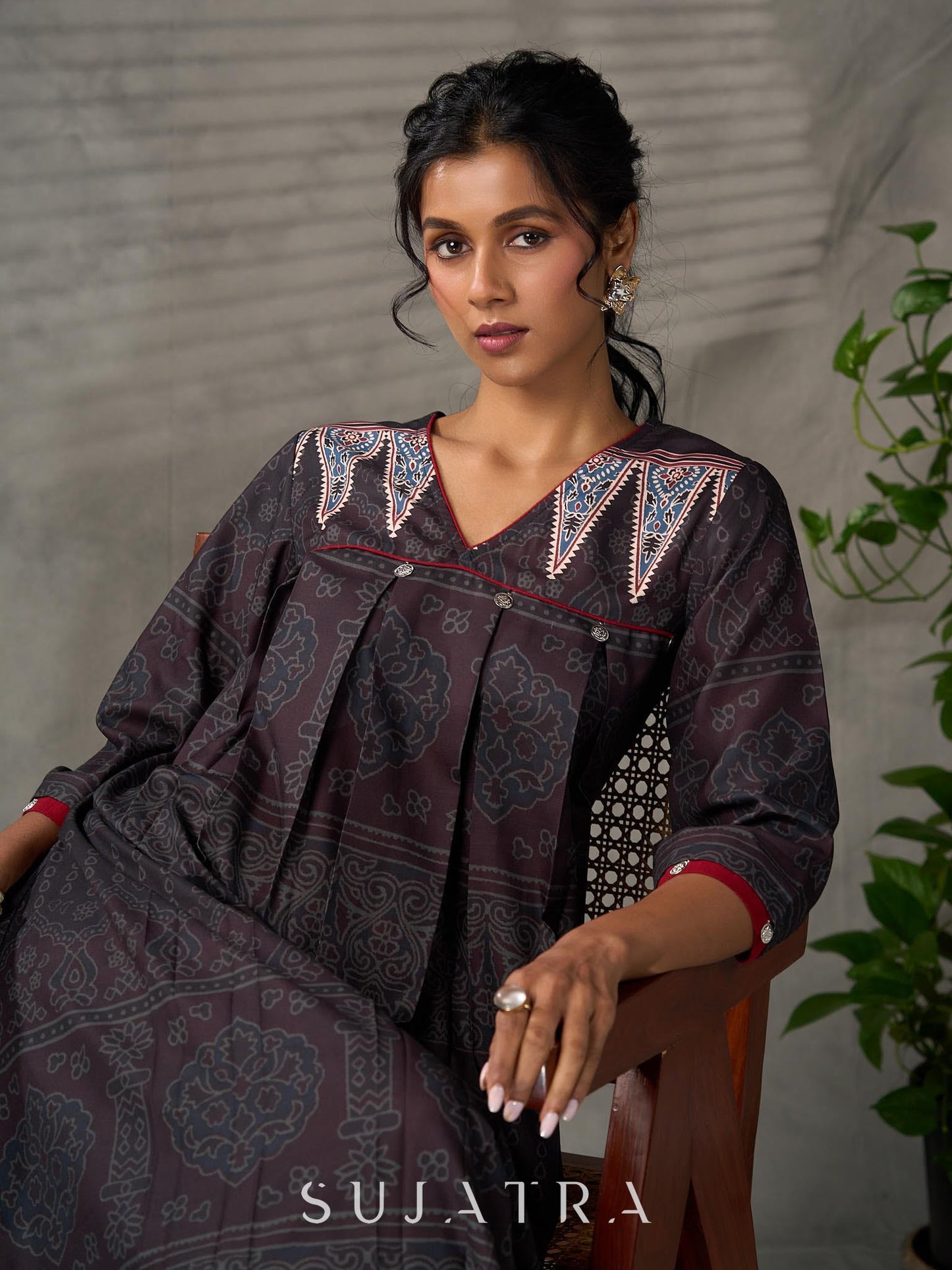 Black Ajrakh printed dress with pleats, maroon accents, and silver embellishments.