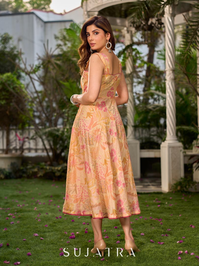 Effortless sunshine yellow floral dress designed with a delicate neckline, gathered straps, and a breezy, flowy form.