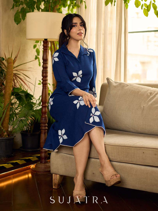 Navy blue apple-cut shirt dress with white floral hand block motifs, conceptually placed and finished with clean white edging and red accents for a refined, contemporary look.