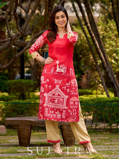 Culturally rooted red kurta displaying classic Warli designs with subtle beige touches