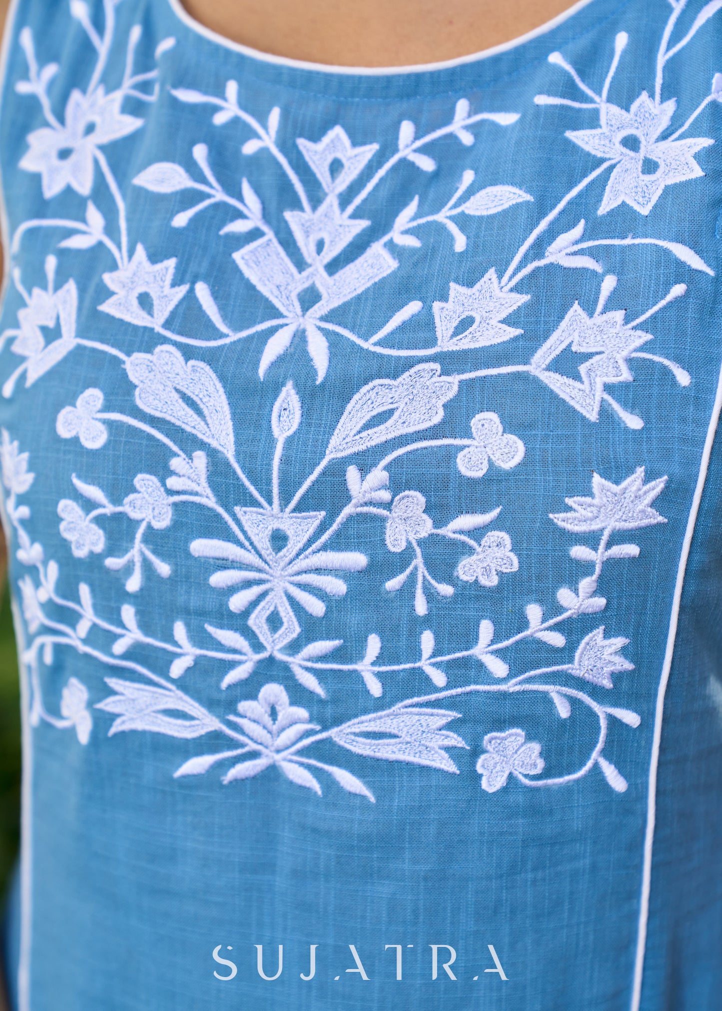 Classy powder blue cotton sleeveless dress highlighted with floral embroidery on the yoke