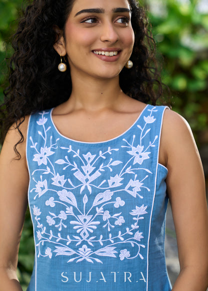 Classy powder blue cotton sleeveless dress highlighted with floral embroidery on the yoke
