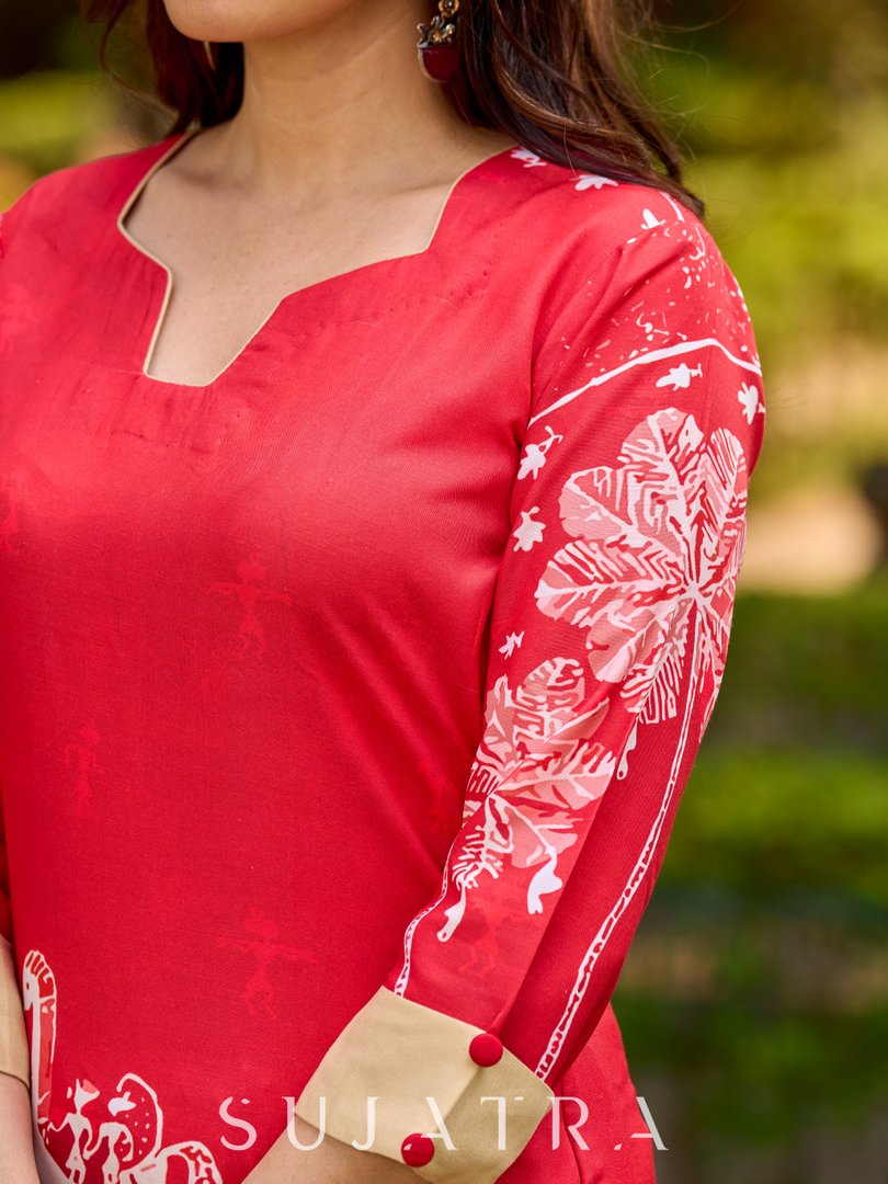 Culturally rooted red kurta displaying classic Warli designs with subtle beige touches