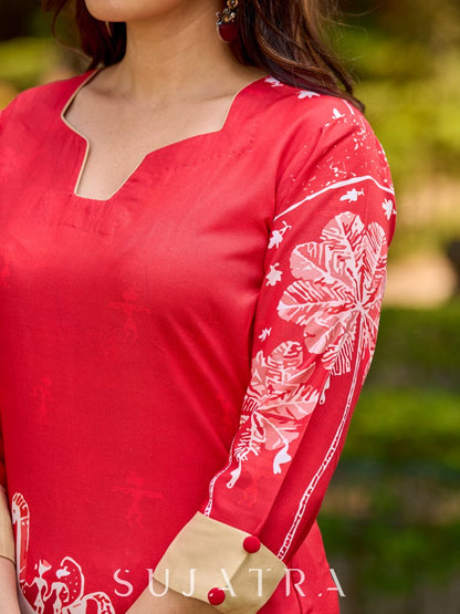 Culturally rooted red kurta displaying classic Warli designs with subtle beige touches