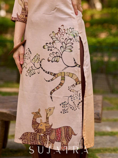 Artisanal cream kurta adorned with Gond-inspired motifs and classic brown accents