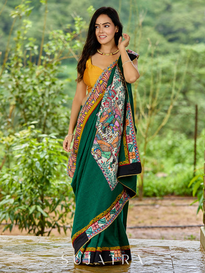 Artisanal cotton saree in bold green with Madhubani hand painted charm
