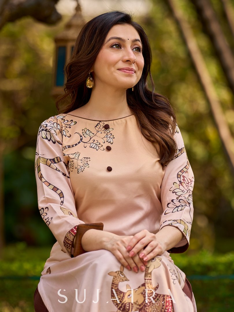Artisanal cream kurta adorned with Gond-inspired motifs and classic brown accents
