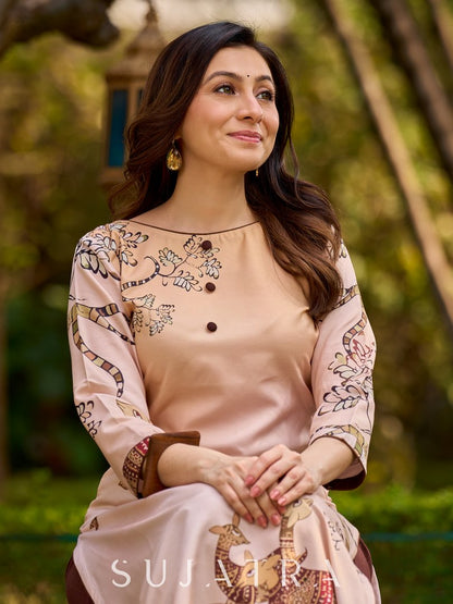 Artisanal cream kurta adorned with Gond-inspired motifs and classic brown accents
