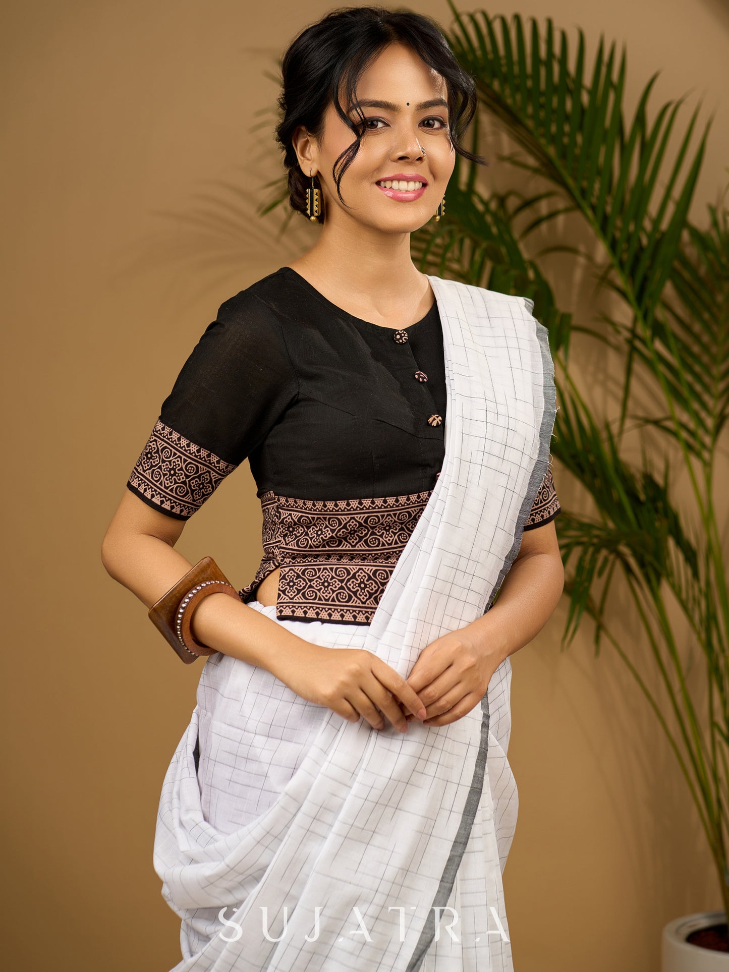 Trendy combination of black cotton ajrakh blouse .