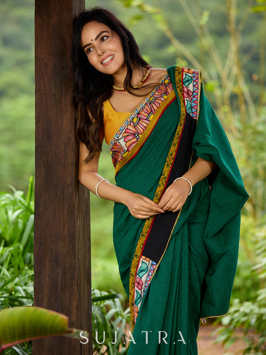 Artisanal cotton saree in bold green with Madhubani hand painted charm