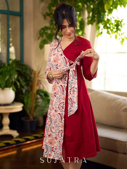Jaipur-printed maroon floral crossover dress featuring a wrap-style silhouette with a coordinating floral tie-up, creating a flattering cinched waist and a breezy, feminine flow.