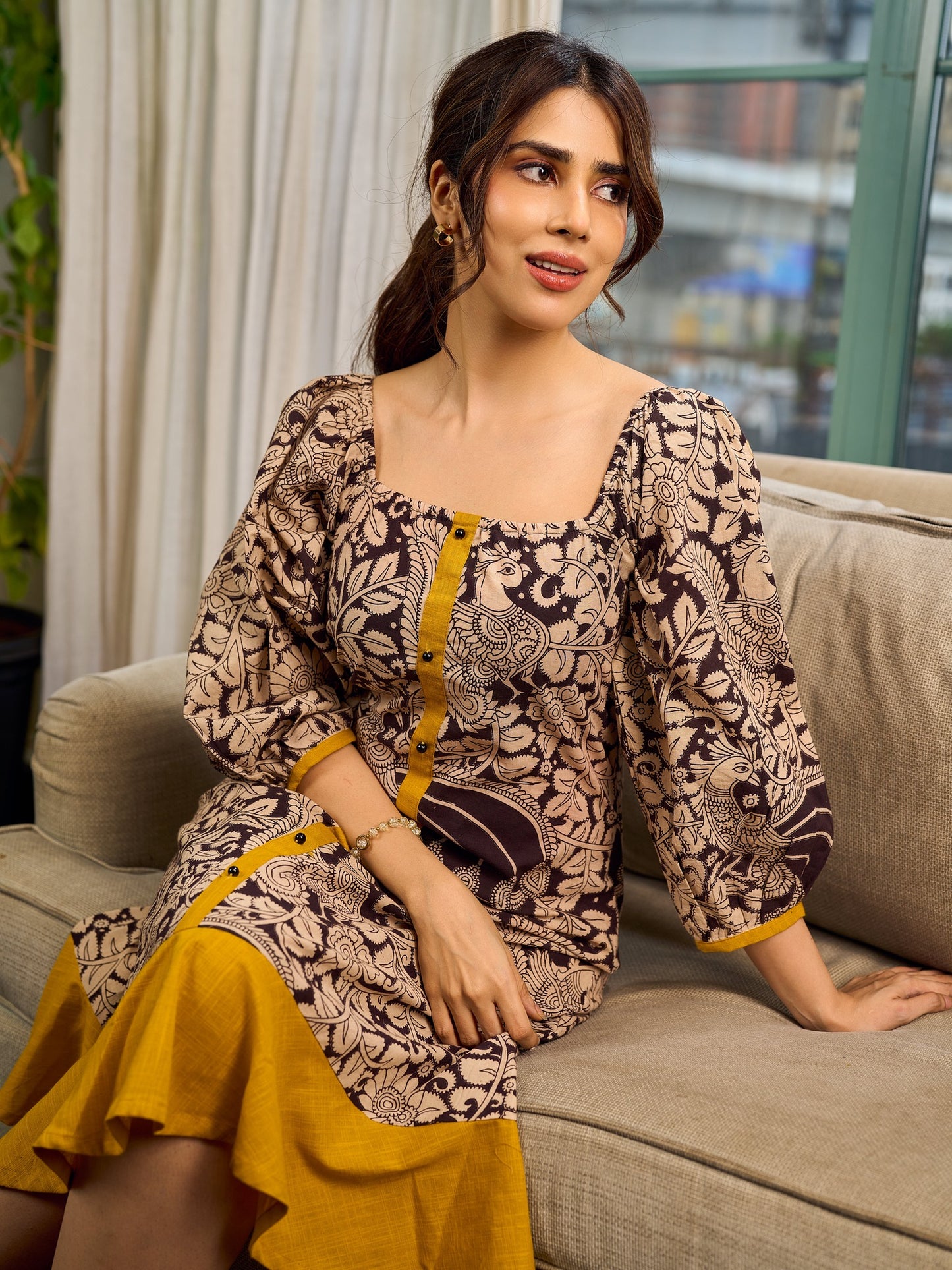 Heritage Kalamkari dress with elegant mustard accents and black pearl embellishments.