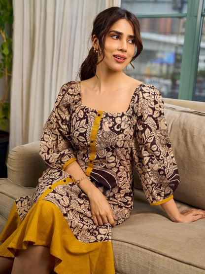 Heritage Kalamkari dress with elegant mustard accents and black pearl embellishments.