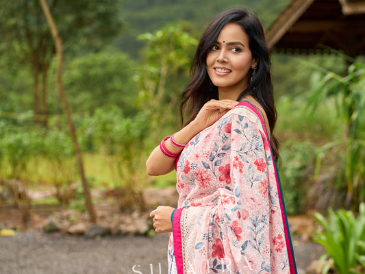 Floral-inspired white saree elevated with fuchsia pleats and borders