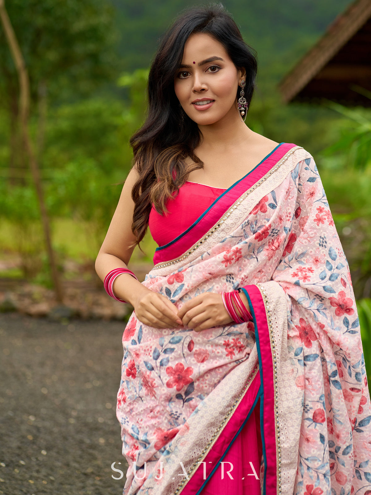 Floral-inspired white saree elevated with fuchsia pleats and borders