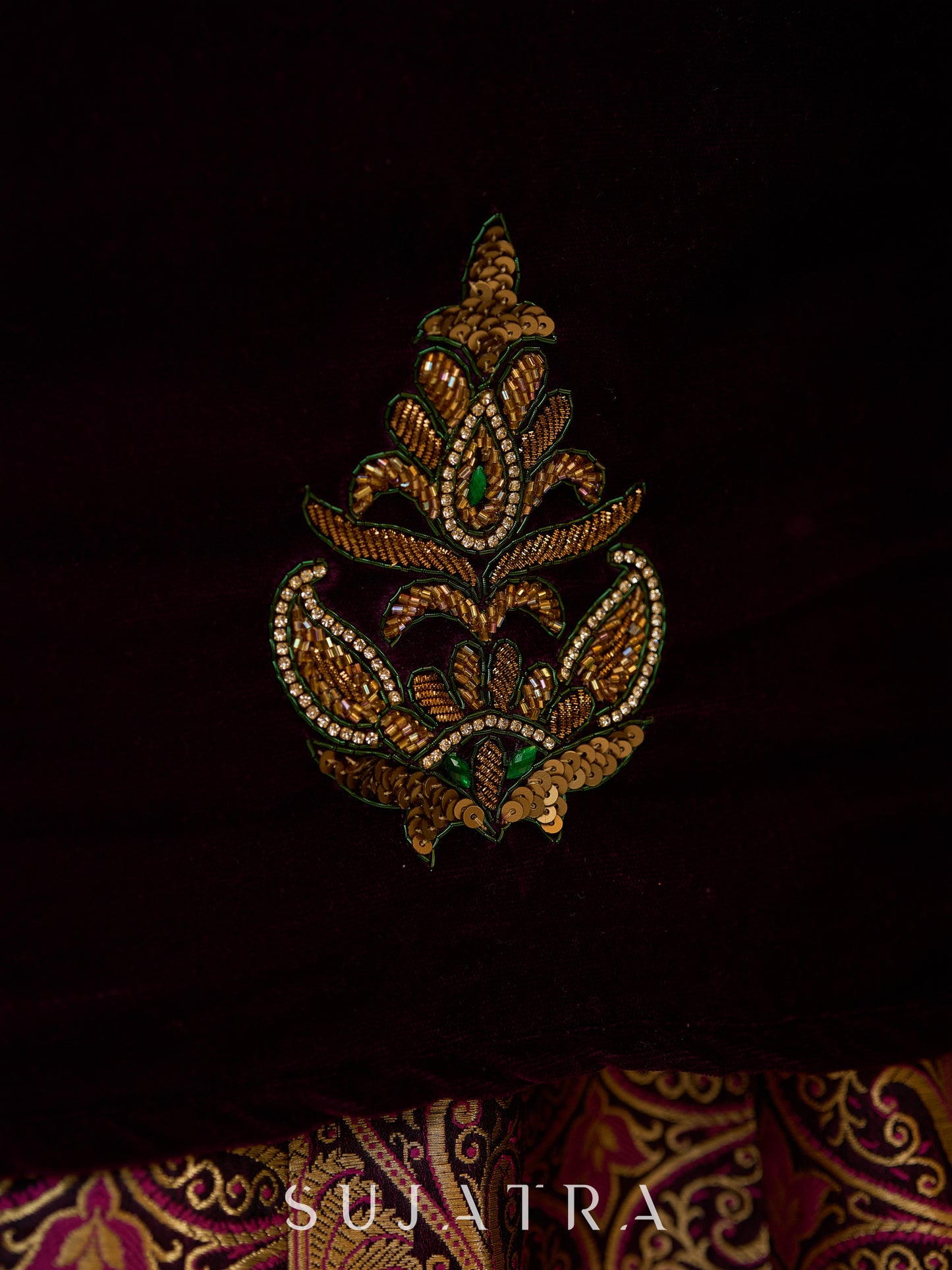 Royal Wine Lehenga with a scalloped hem and a luxurious velvet choli with Zardosi work .