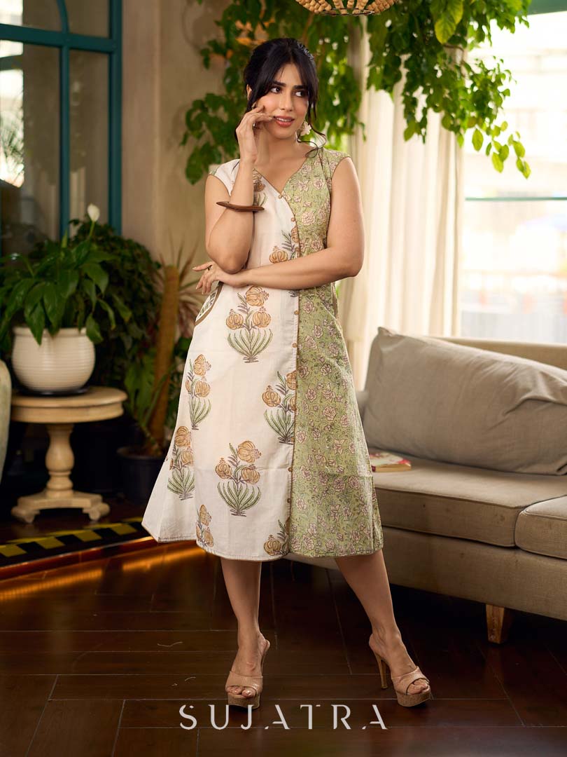 Jaipur-printed sleeveless dress featuring a half-and-half butta and jaal combination, designed with an overlapping silhouette, soft drop shoulders, and wooden accents for an artisanal, contemporary look.