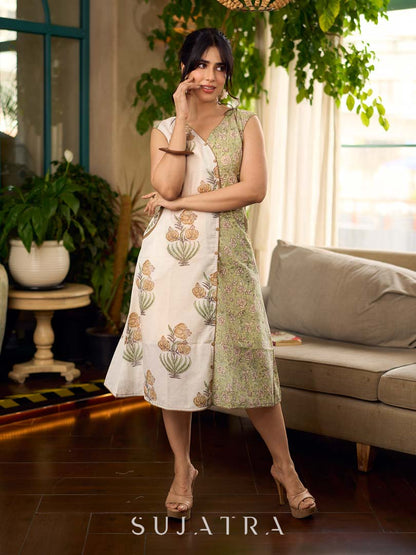 Jaipur-printed sleeveless dress featuring a half-and-half butta and jaal combination, designed with an overlapping silhouette, soft drop shoulders, and wooden accents for an artisanal, contemporary look.