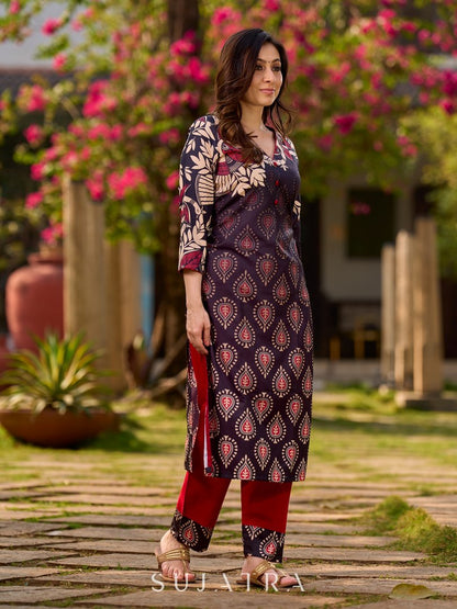Statement black kurta with Kalamkari-inspired ombré prints and vibrant red touches.