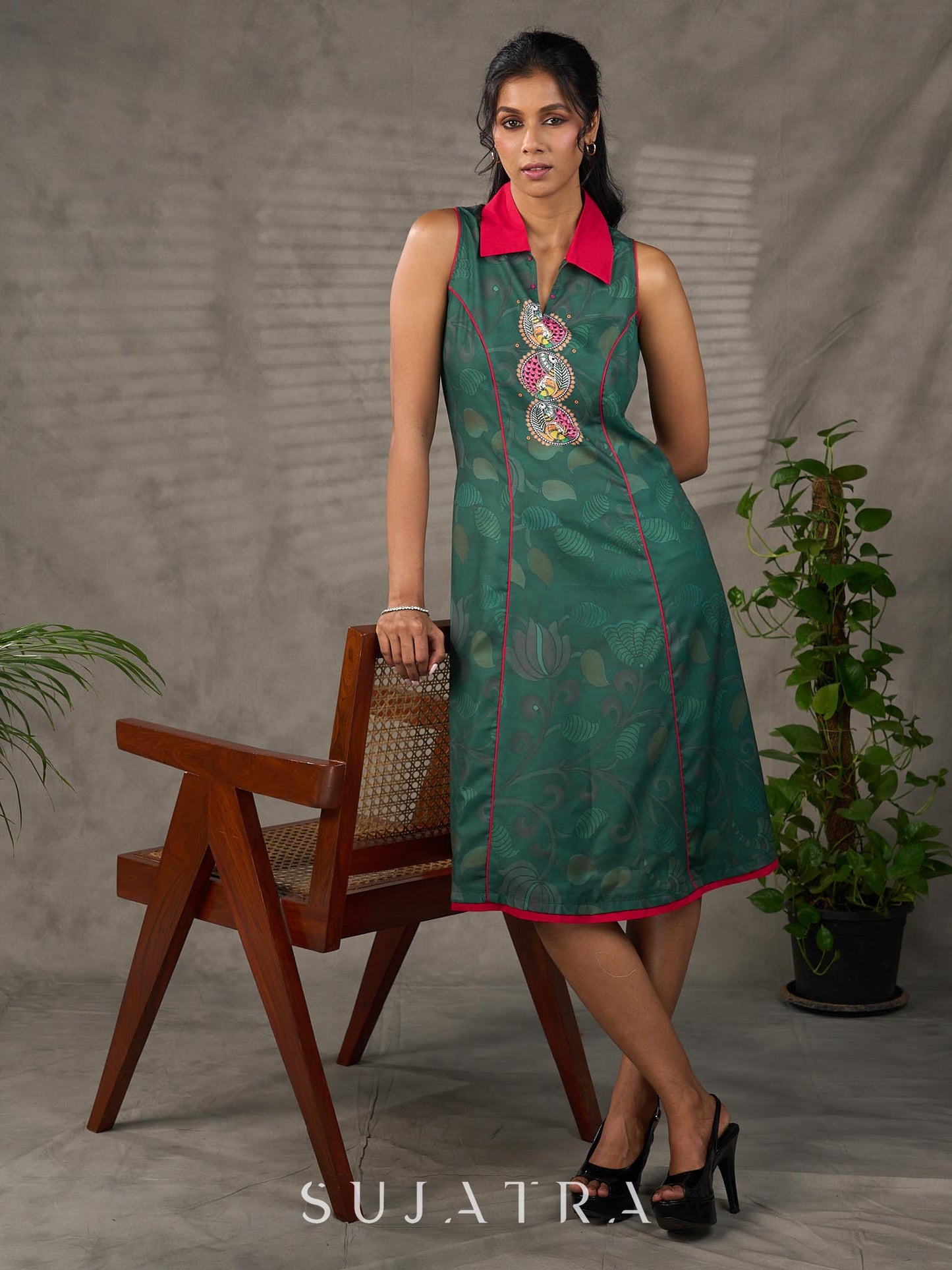 Bottle green Madhubani printed dress with vibrant magenta accents.