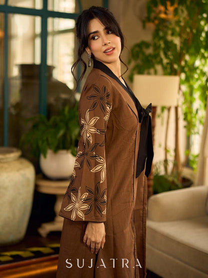 Brown block print dress with floral block printed flared sleeves, black tie-up neckline, and contrast black accents for an effortless, elegant everyday look.