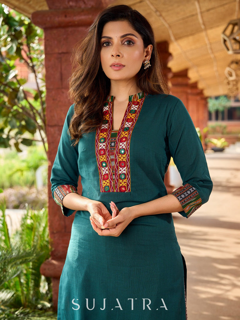 Dark green cotton kurta adorned with traditional Kutch mirror work-ikkat pant optional.