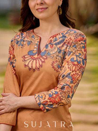 Elegant mustard kurta featuring Kalamkari print in an asymmetrical layout