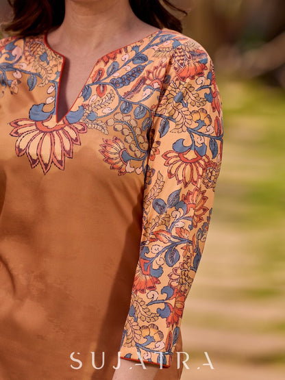 Elegant mustard kurta featuring Kalamkari print in an asymmetrical layout
