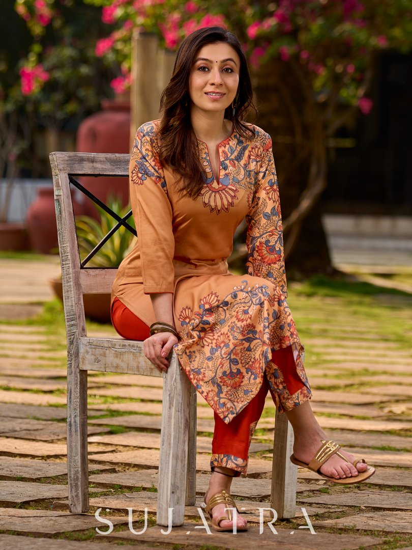 Elegant mustard kurta featuring Kalamkari print in an asymmetrical layout