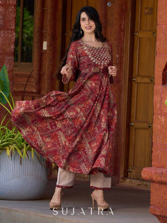 Exquisite deep maroon printed kurta with a graceful bias silhouette, intricate handwork on the yoke, and scalloped sleeve detailing.