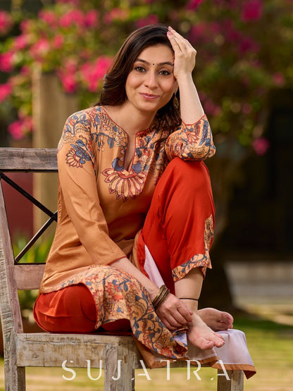 Elegant mustard kurta featuring Kalamkari print in an asymmetrical layout